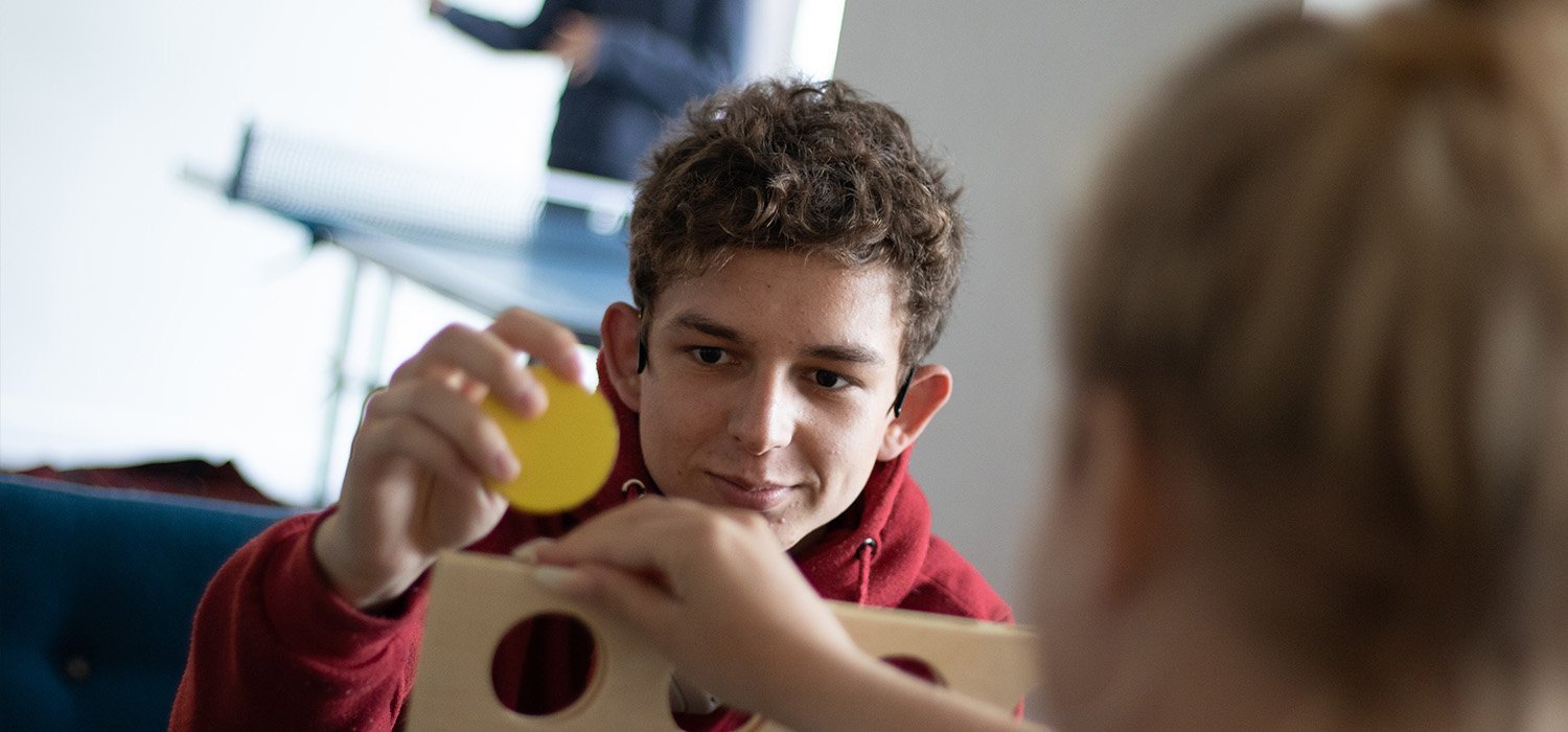 young person playing connect four