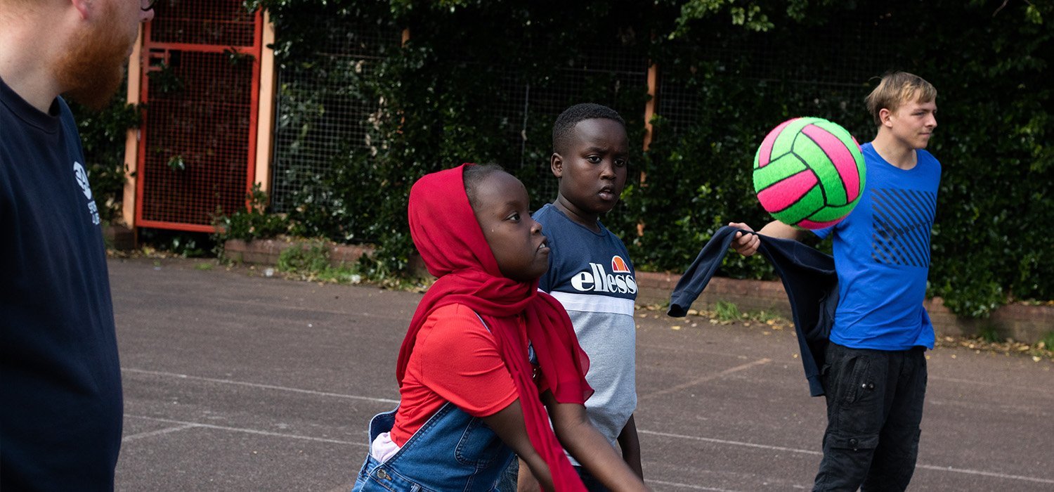 Young people playing volleyball in Birmingham