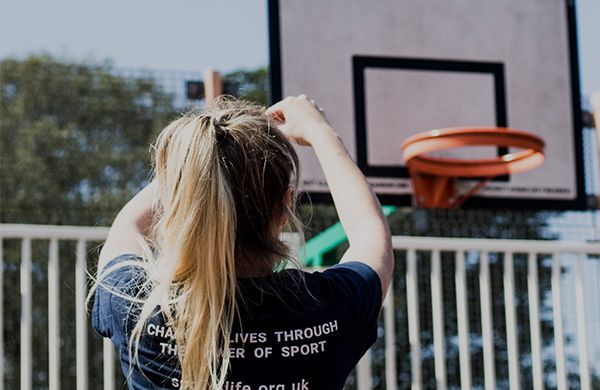 Young person playing basketball in sport 4 life t-shirt